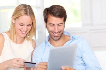 Young couple at home doing online shopping
