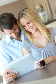 Young couple at home using electronic tablet