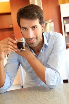 Handsome man having coffee at home