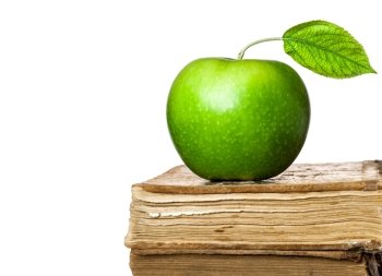 Green apple on old books isolated on white background. School concept