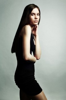 Fashion portrait of young beautiful elegant woman in the black dress