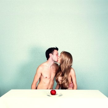 Two young nude lovers with red apple