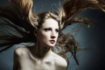 Fashion portrait of the young sexy woman with flying hair
