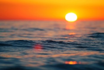 calm summer wave at the sunset, shallow DOF