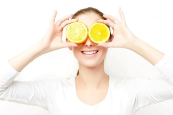Portrait of young cheerful woman with two slices of orange
