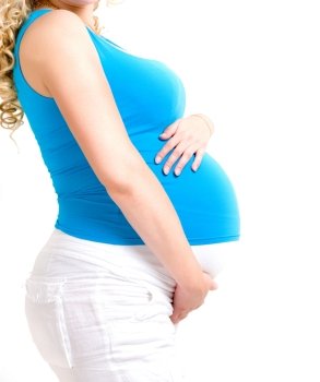 pregnant woman showing her big tummy, isolated over white