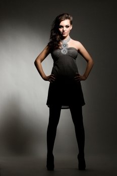 young gorgeous brunette model posing in the studio, dramatic lighting