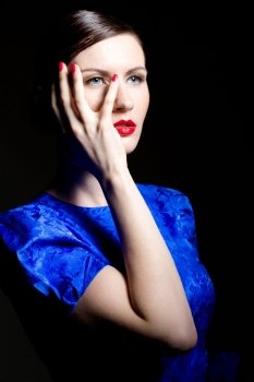 young caucasian woman in blue dress posing, studio shot