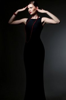 young caucasian woman in back dress posing, studio shot