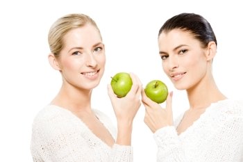 two young smiling caucasian women holding apples