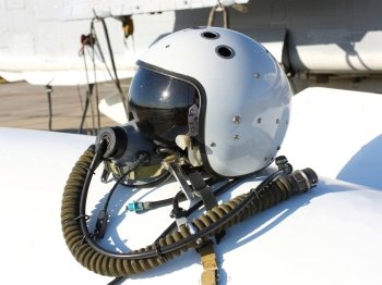 Protective helmet of the pilot against the plane with an oxygen mask on a fuel tank