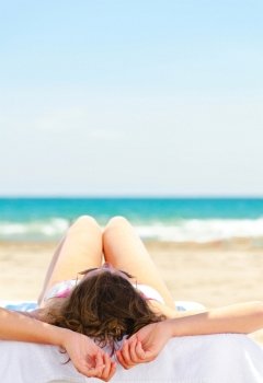 woman is lying at tropical beach near sea