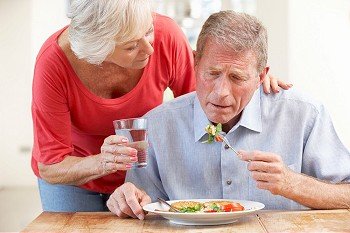 Senior woman looking after sick husband