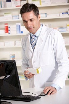 American pharmacist working on computer