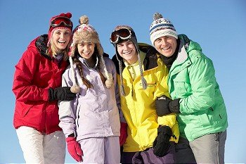Teenage Family On Ski Holiday In Mountains