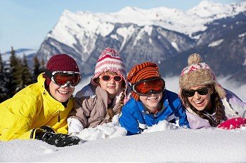 Group Of Children Having Fun On Ski Holiday In Mountains