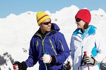 Couple Having Fun On Ski Holiday In Mountains