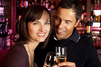 Couple Enjoying Drink Together In Bar