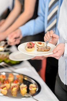 Catering at business company event people choosing buffet food appetizers