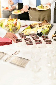 Appetizers mini desserts on catering buffet white tablecloth business event