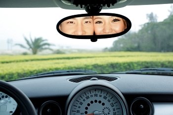 Couple posing in car mirror