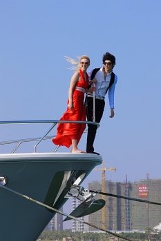 Man and woman looking over bow of boat