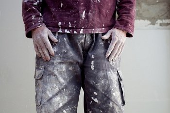 hands and white dirty trousers detail of plastering painter man