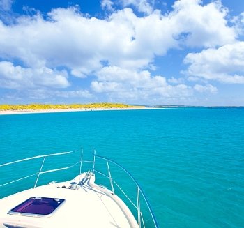Boat anchored in Formentera Espalmador in turquoise Balearic island