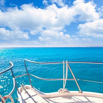 Anchor boat y tropical idyllic tropical turquoise beach under blue sky and clouds