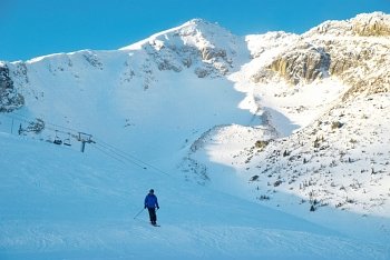 Skier on the mountain slope. Winter landscape.