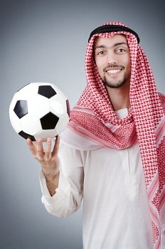 Arab with football in studio shooting