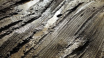 Tire patterns on the mud with reflection and water, selective focus