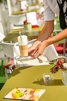 Waitress hands close up serving latte cafe bar terrace sunny