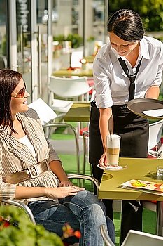 Waitress serve woman latte at cafe bar terrace sunny day