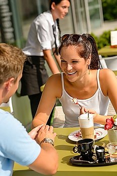 Couple enjoy coffee dessert restaurant sunny terrace eat cheesecake