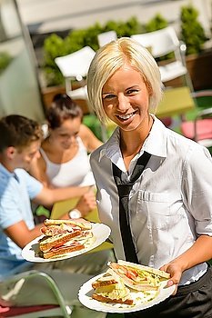 Waitress bringing sandwiches on plates fresh lunch restaurant terrace