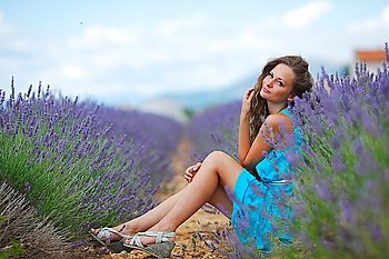 Woman sitting on a lavender field