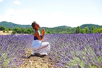 Woman sitting on a lavender field