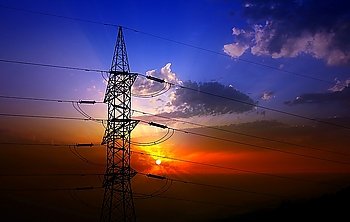Dramatic clouds sky and electric tower backlight silhouette