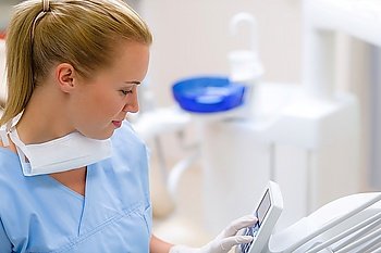 Dental assistant use modern stomatology technology prepare medical tools