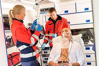 Paramedic putting oxygen mask on patient ambulance sick emergency