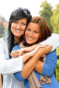 Teen and her mother embracing outdoors bonding daughter happy relaxing