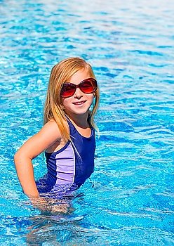 blond kid girl in blue pool posing with sunglasses smiling