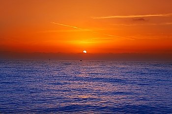 Sunrise sunset in mediterranean sea with orange sky and blue water