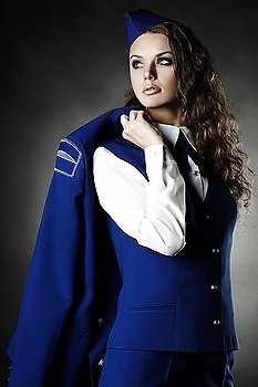 portrait of beautiful young woman with uniforme black background studio photo