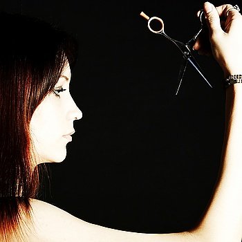 Scissors in the beautiful woman s hand studio photo shooting