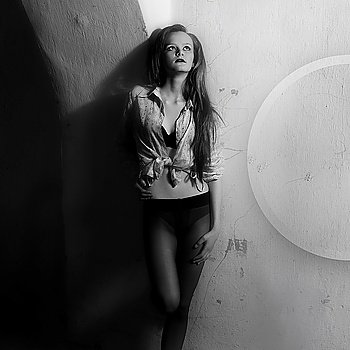 Young sexy woman against the wall. Black and white photo art fashion
