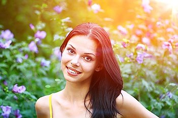 portrait of sexy girl on the background of flowers