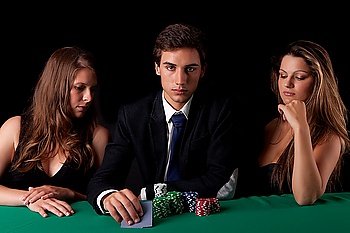 Young handsome man playing texas hold´em poker