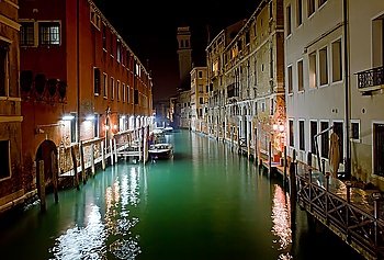 Venice channel at night with boats